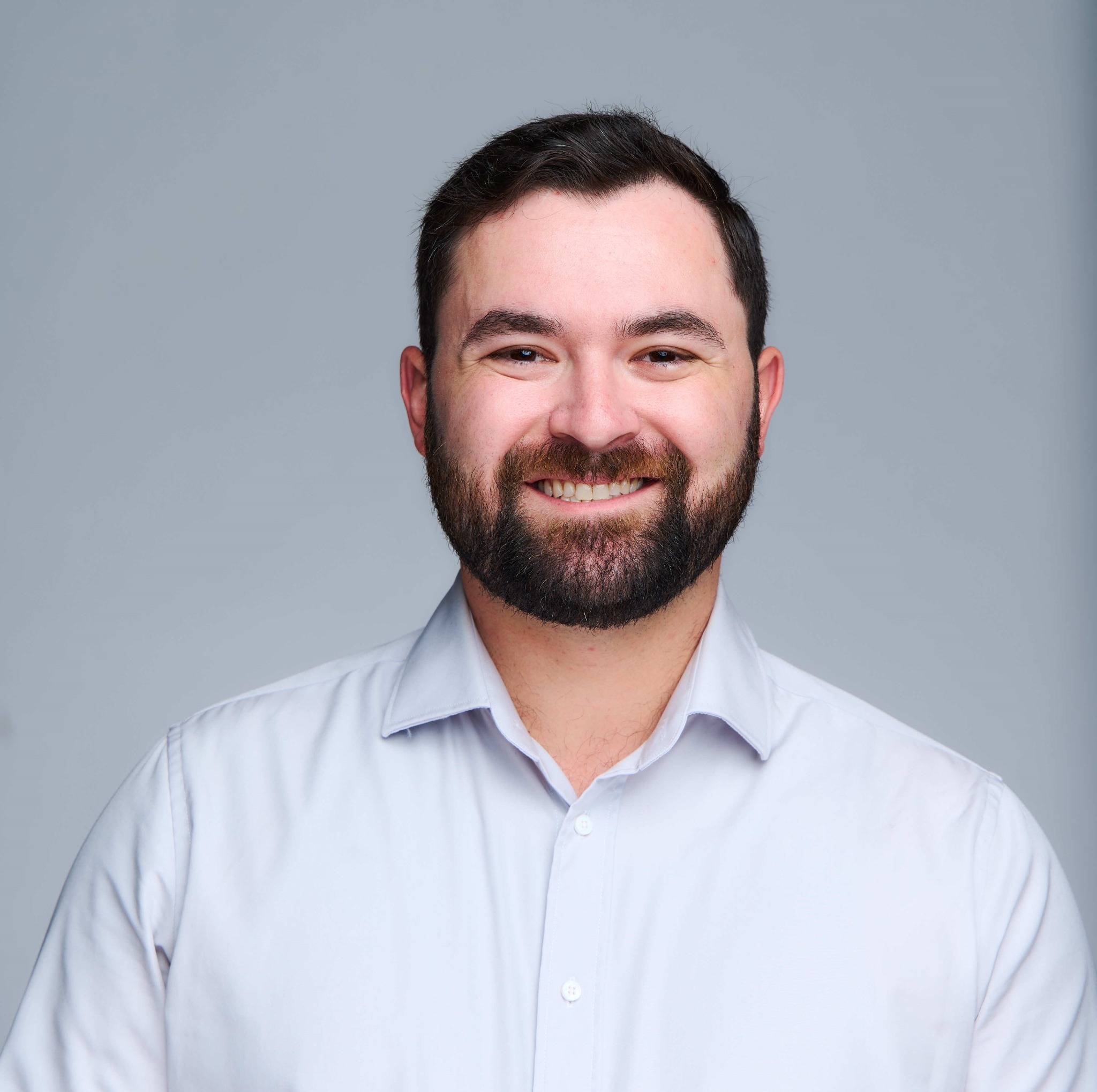 Jordan Robinson smiling in a professional headshot.